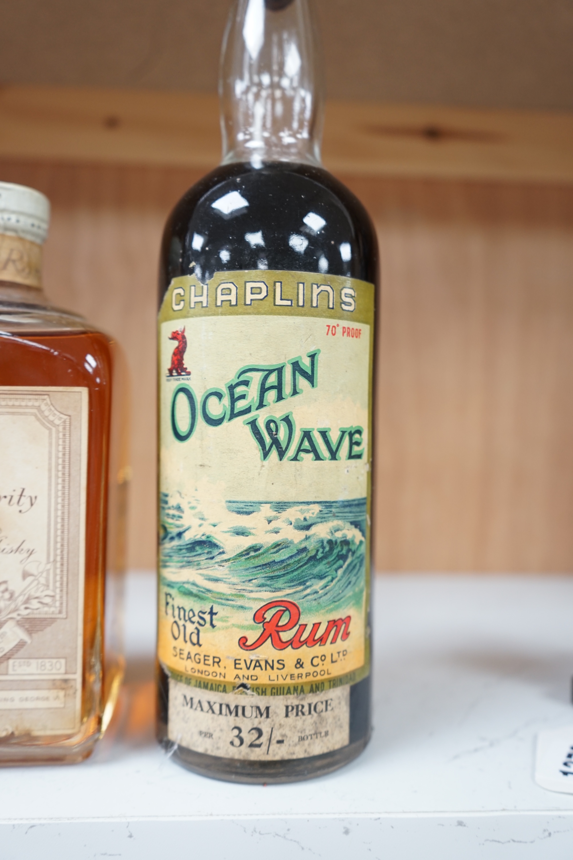 A bottle of Bulloch Lade’s Old Rarity Scotch Whisky and a bottle of Seager, Evans & Co, Ltd., Chaplins Ocean Wave finest old Rum, (2). Condition - fair, storage history unknown